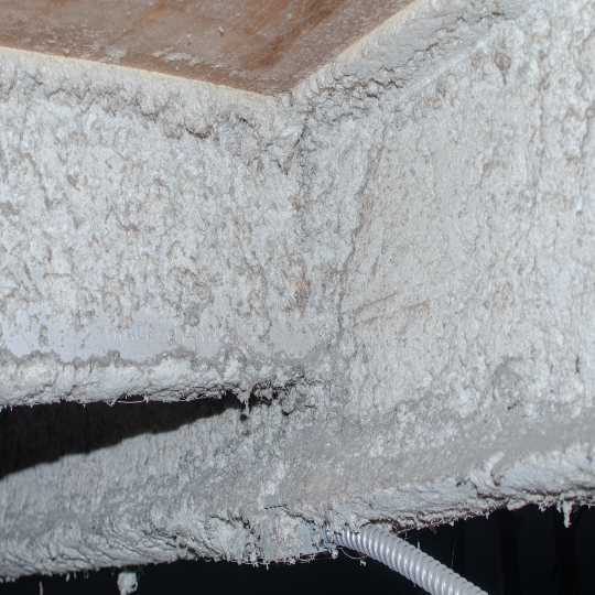 Asbestos containing material that has been found inside of a commercial building.