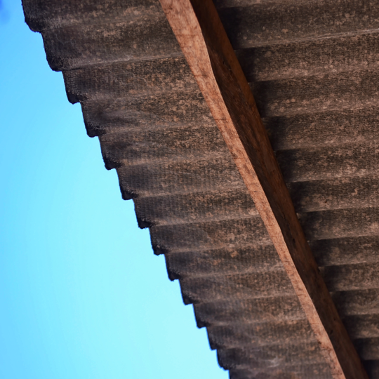 Image of asbestos roof tiles against blue sky