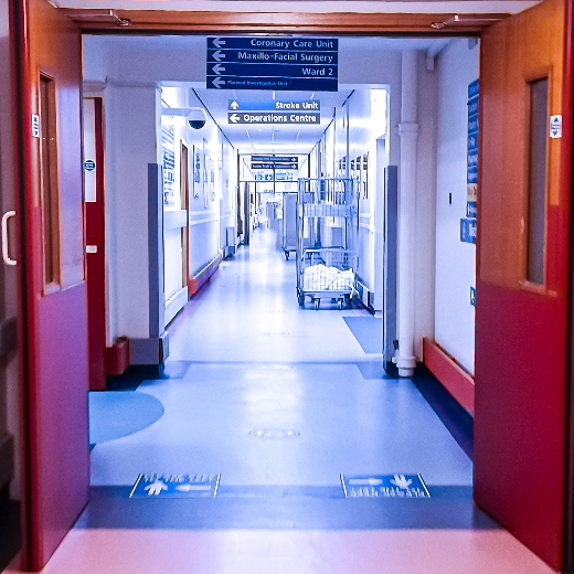 Open doors in a hospital leading to a hallway.