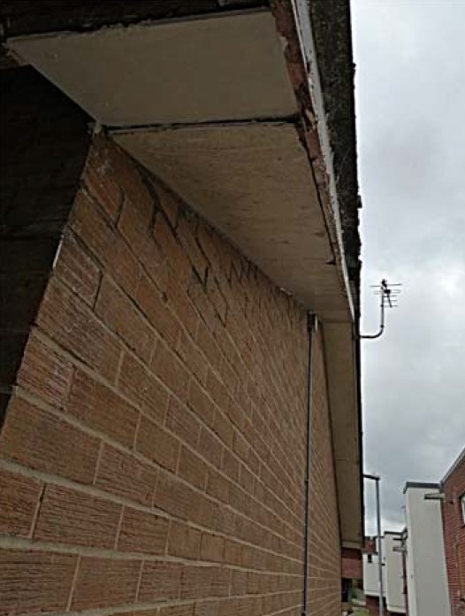 Asbestos insulating board soffits pictured on the outside of a building.