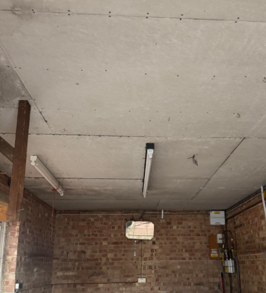 A modern wooden attic with insulating boards stacked up.