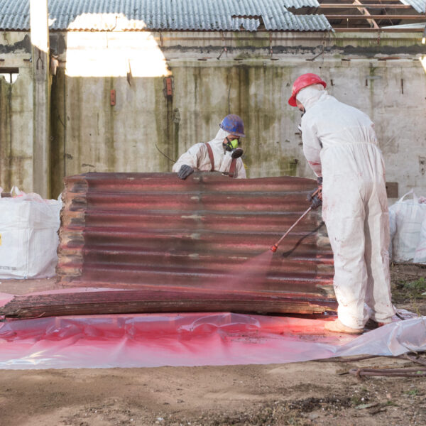 Workers encapsulating asbestos