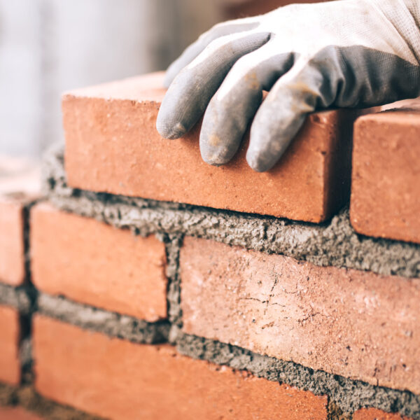 Construction worker building a wall with bricks