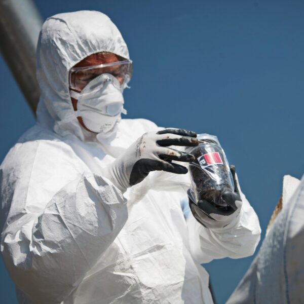 Man removing asbestos from roof