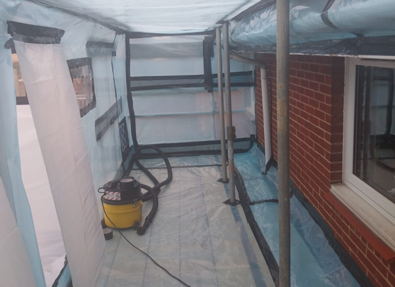 Internal view of decontamination unit during asbestos removal process.