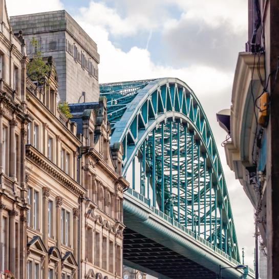 The Tyne bridge pictured behind a historic building in Newcastle.