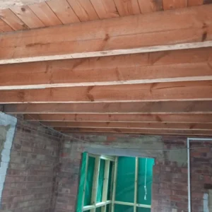 Garage ceiling after completion of the asbestos removal service which uncovered wood rafter ceiling work.